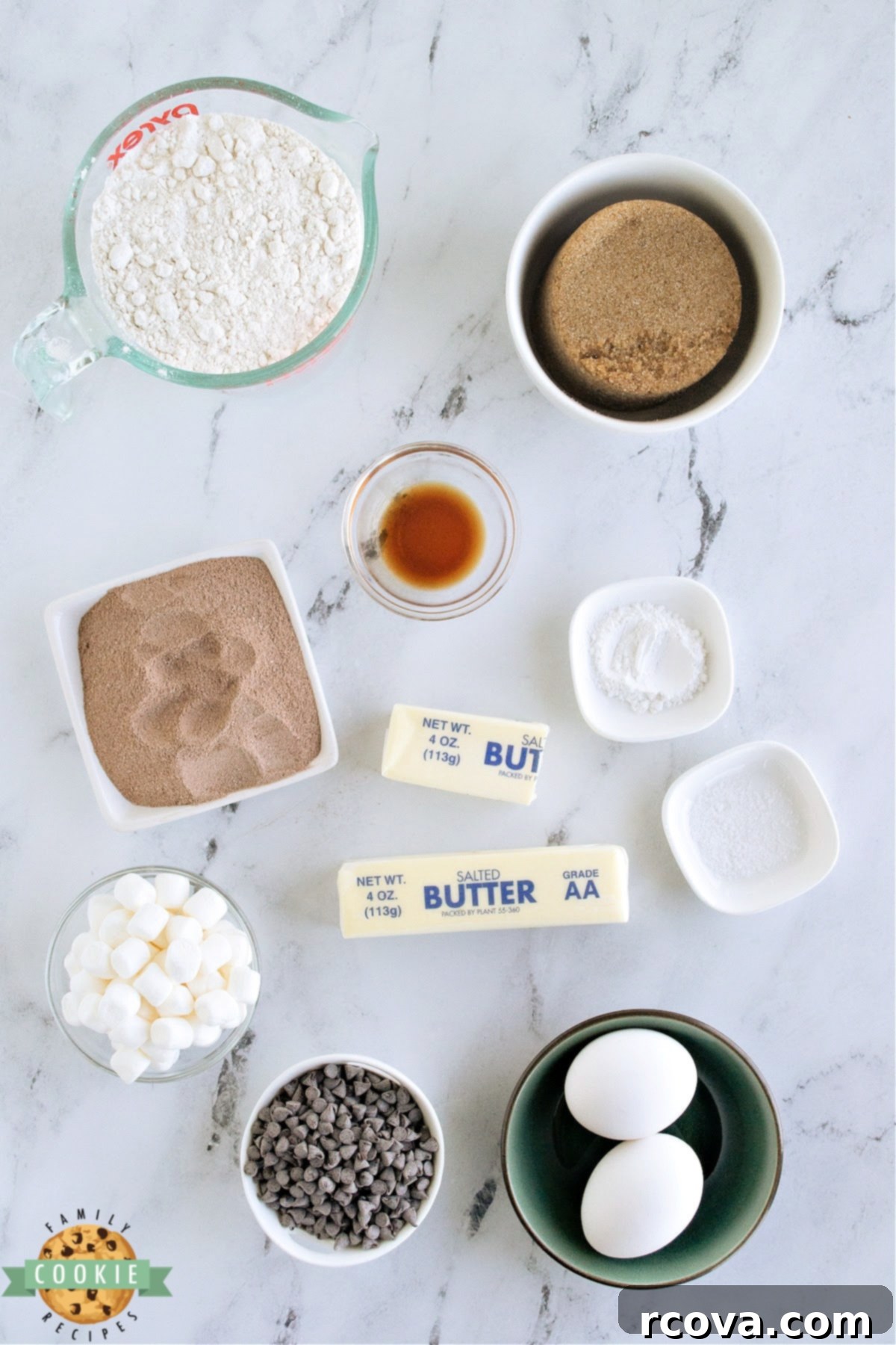 Swiss Miss Chocolate Chip Cookie Bar Bliss 4 Array of ingredients laid out for Swiss Miss Chocolate Chip Cookie Bars, including flour, butter, sugar, hot cocoa mix, marshmallows, and chocolate chips.