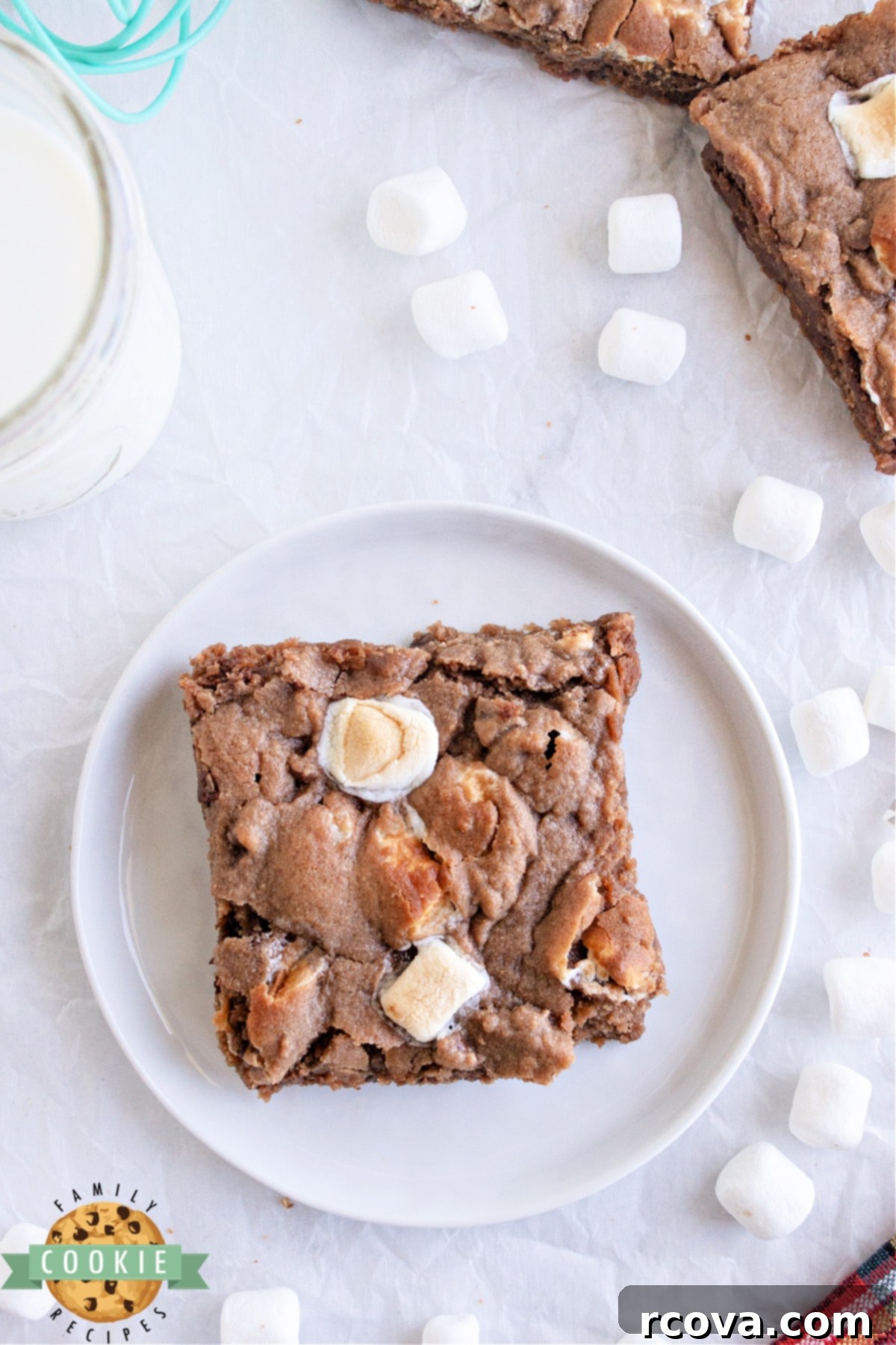 Swiss Miss Chocolate Chip Cookie Bar Bliss 8 A stack of hot cocoa chocolate chip cookie bars with melted marshmallows, inviting a delicious bite.