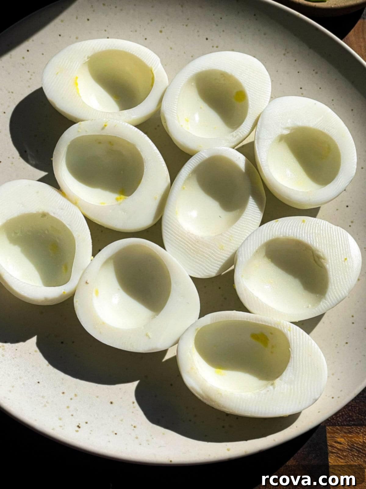 Instant Pot Deviled Eggs Fast & Fabulous 6 Hands carefully peeling a perfectly cooked hard-boiled egg, showing how easily the shell comes off.
