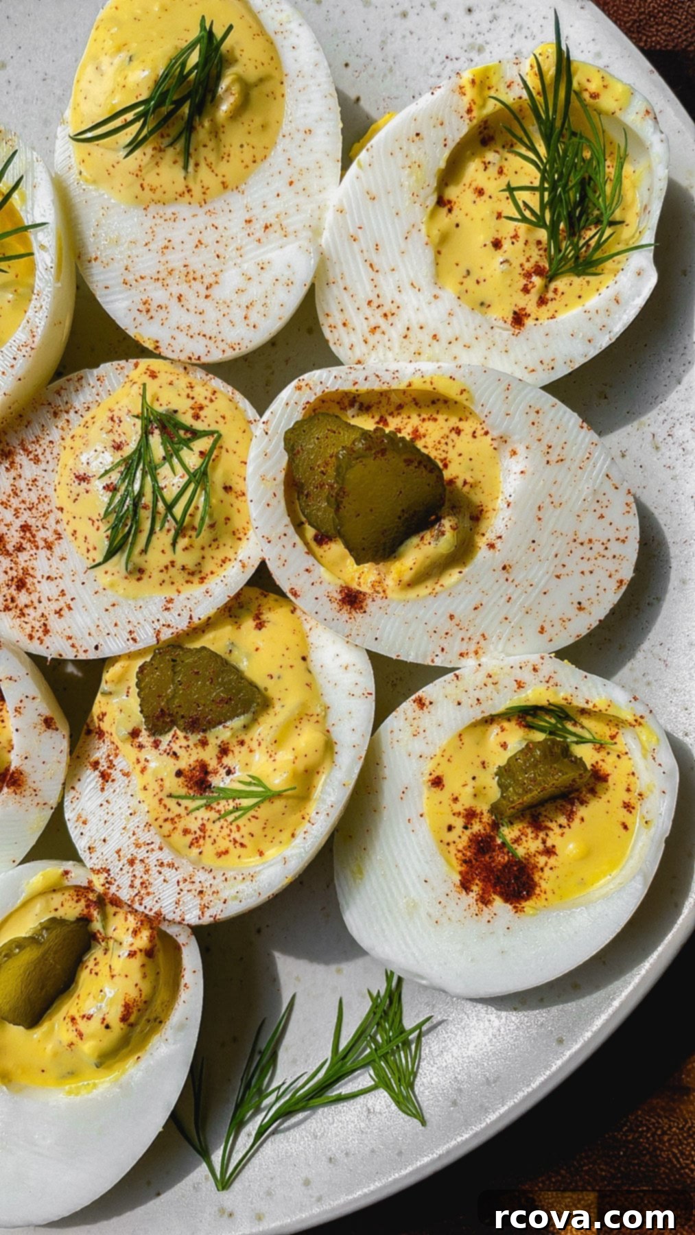 Zingy Pickle Deviled Eggs 8 A completed Southern deviled egg, beautifully piped and garnished, ready to be picked up.
