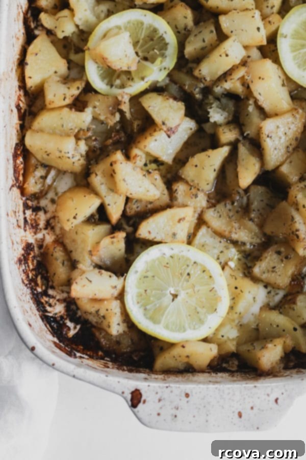 Whole30 Greek Lemon Roasted Potatoes 2 A serving of golden, crispy Greek Lemon Potatoes, garnished with fresh herbs, ready to be enjoyed.