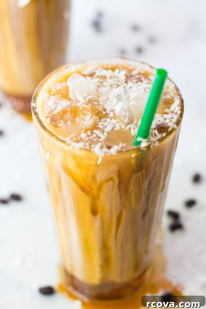 Tropical Salted Caramel Iced Macchiato 4 Close-up of the caramel drizzle and coconut flakes on top of an Iced Coconut Milk Caramel Macchiato.