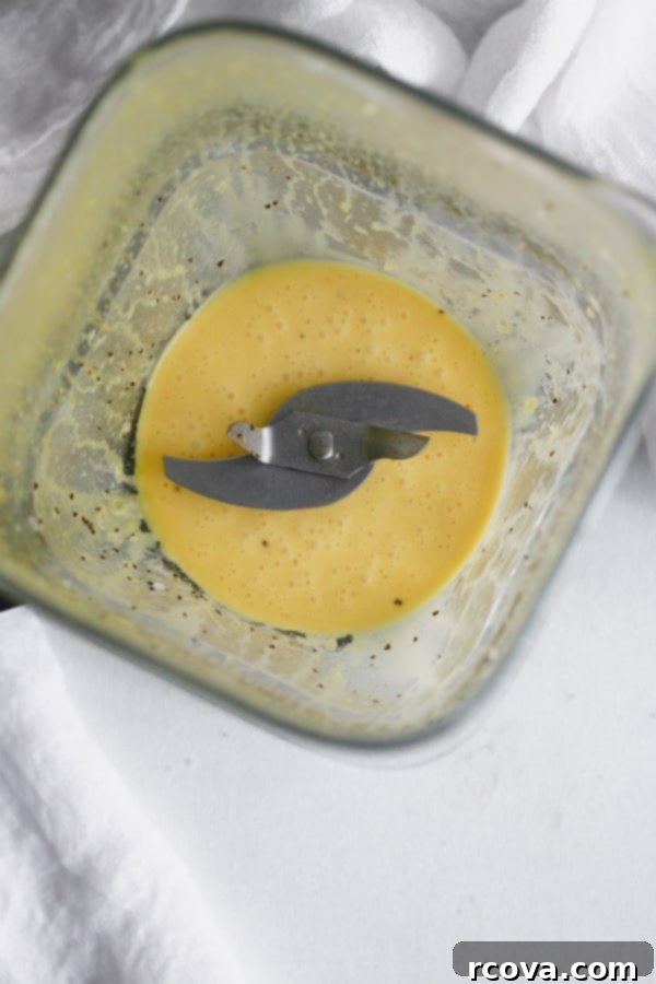 Easy Whole30 Blender Hollandaise 4 Fresh ingredients laid out for making Whole30 Blender Hollandaise Sauce, including eggs, lemon, ghee, and cayenne pepper.