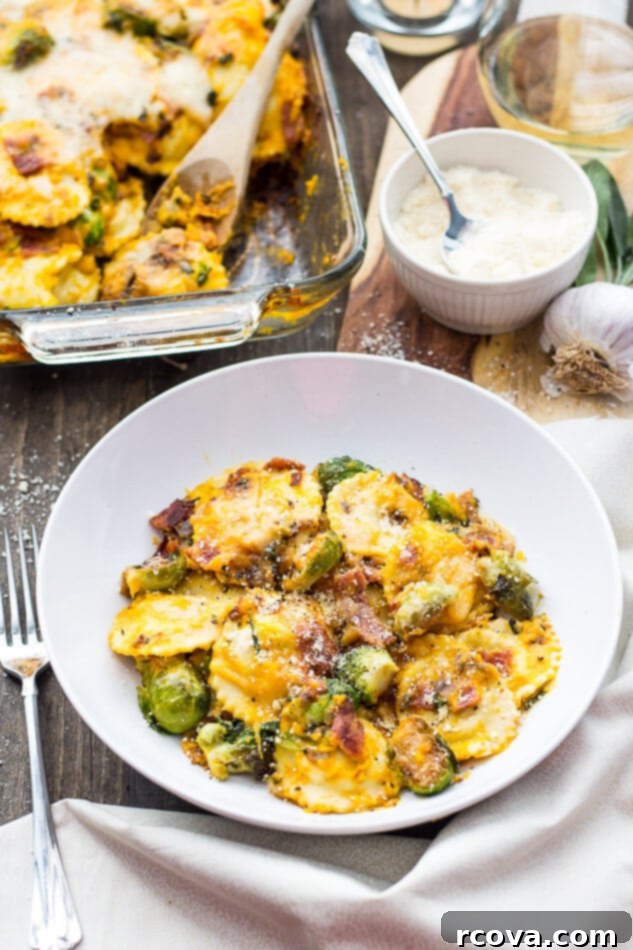 Butternut Squash Ravioli Casserole 8 Butternut Squash Ravioli Bake in a baking dish, with a serving removed and a spoon nearby.