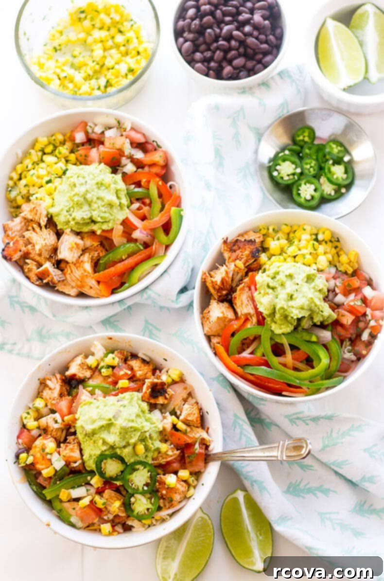 Chipotle Chicken Bowl Extravaganza 4 A close-up shot of a prepared Chipotle Chicken Burrito Bowl, showcasing the colorful layers and fresh ingredients, including guacamole and salsas.