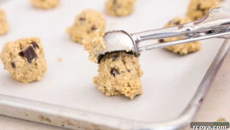Chewy Chocolate Oatmeal Delights 5 Cookie dough being scooped for perfect, evenly sized oatmeal cookies.