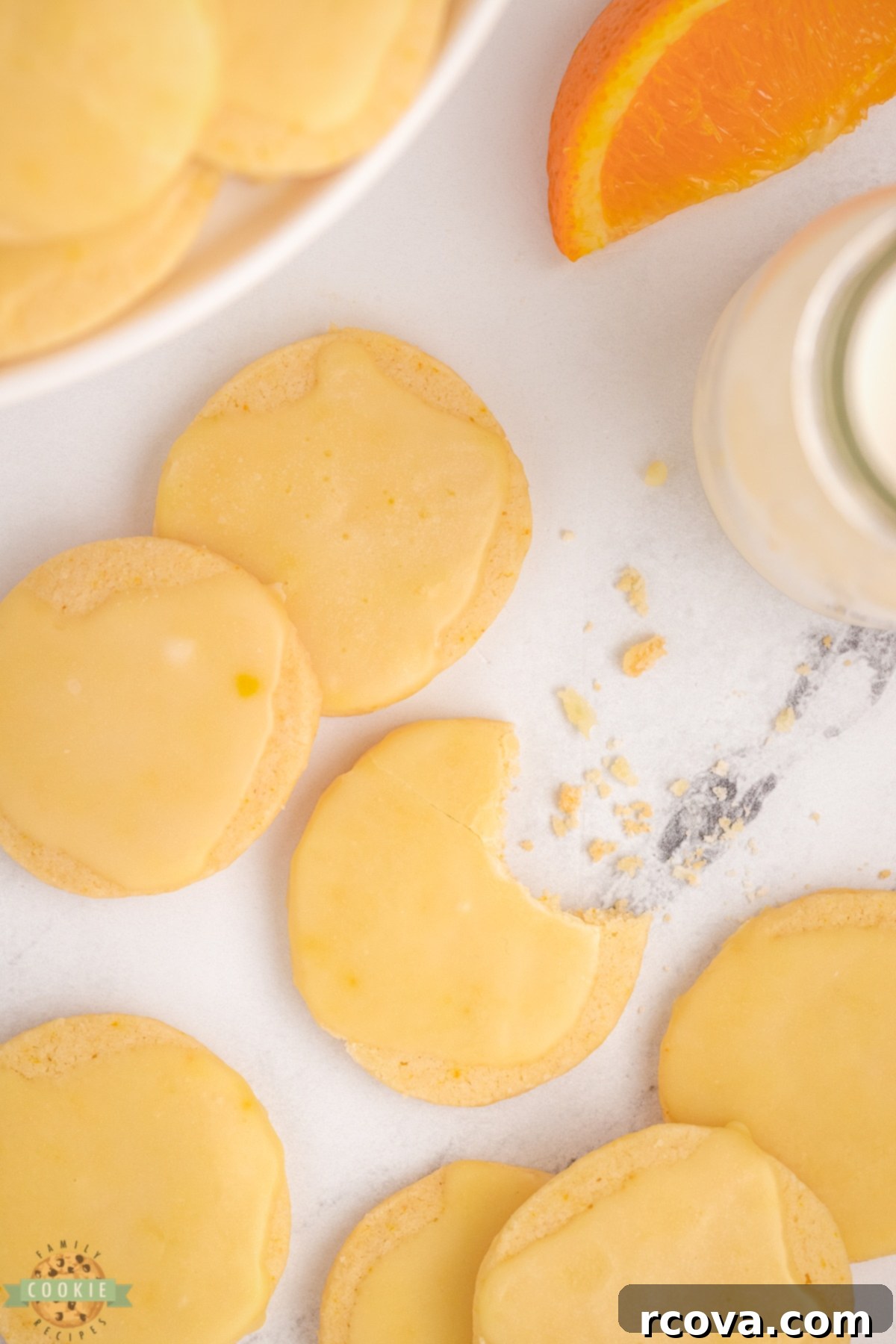 Zesty Orange Shortbread Bites 4 bite taken out of an orange cookie