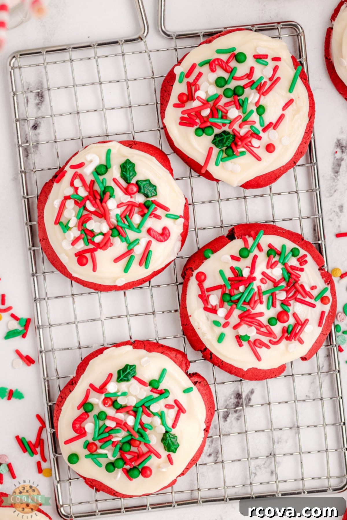 Crimson Velvet Holiday Treats 8 Warm red velvet cookies cooling on a wire rack, waiting for their delicious cream cheese frosting and holiday sprinkles