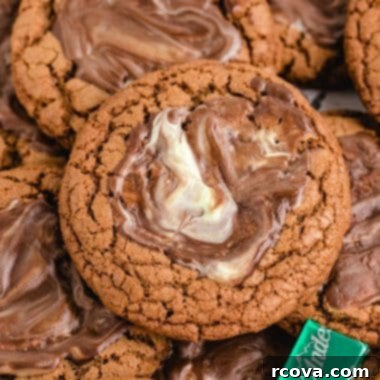 Decadent Andes Mint Chocolate Cookies 6 A stack of freshly baked Andes Mint Chocolate Cookies, topped with melted and swirled Andes mints, indicating a delicious and refreshing treat.
