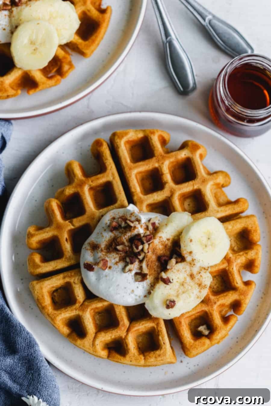 Harvest Pumpkin Paleo Waffles 2 pumpkin waffle made with almond flour topped with whipped cream, bananas, pumpkin pie spice and pecans. Maple syrup to the right