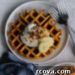 Harvest Pumpkin Paleo Waffles 6 pumpkin waffle on a plate with whipped cream, bananas, pecans and pumpkin pie spice