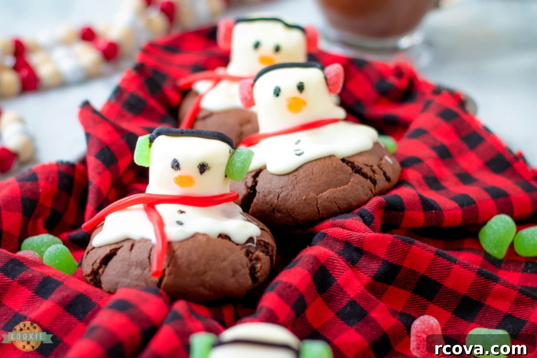 Festive Peppermint Snowman Delights 3 bakery style snowman cookies on a red checked cloth