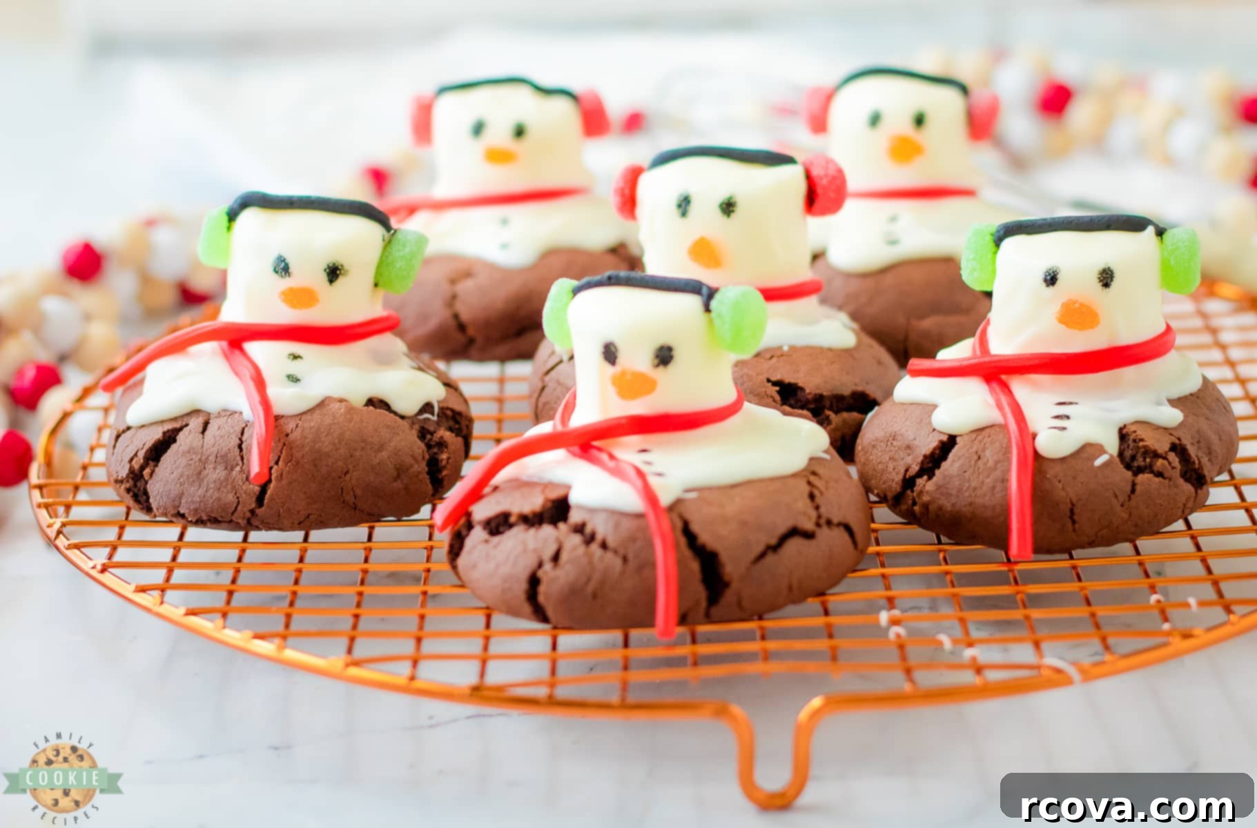 Festive Peppermint Snowman Delights 7 peppermint snowman cookies on a cooling rack