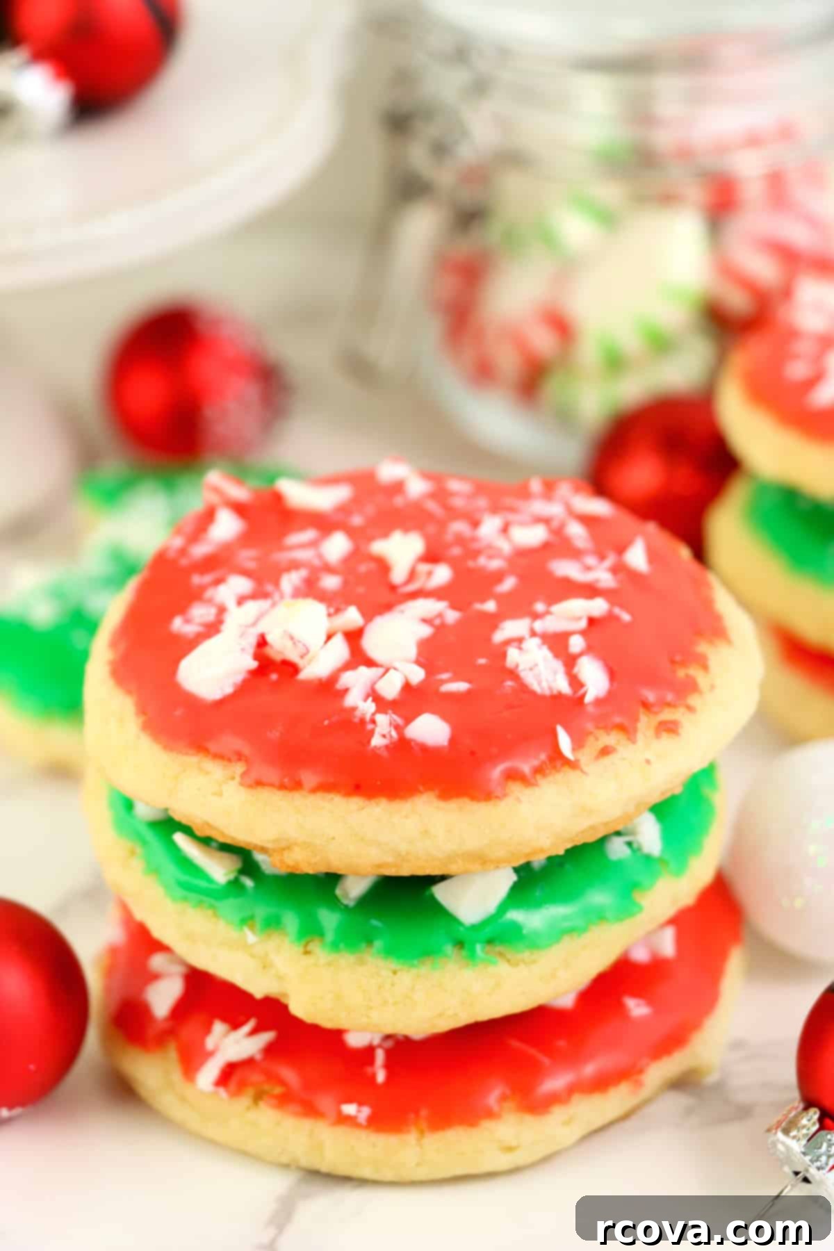 Festive Christmas Sugar Cookies 2 Festive Christmas Sugar Cookies with red and green frosting and crushed mints, perfect for holiday gatherings.