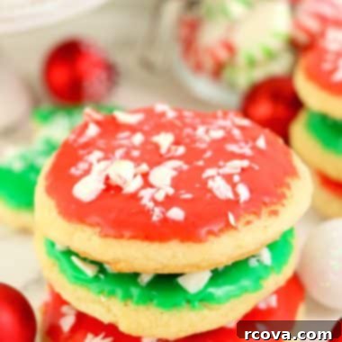 Festive Christmas Sugar Cookies 8 Beautifully frosted and decorated Christmas Sugar Cookies on a white plate.