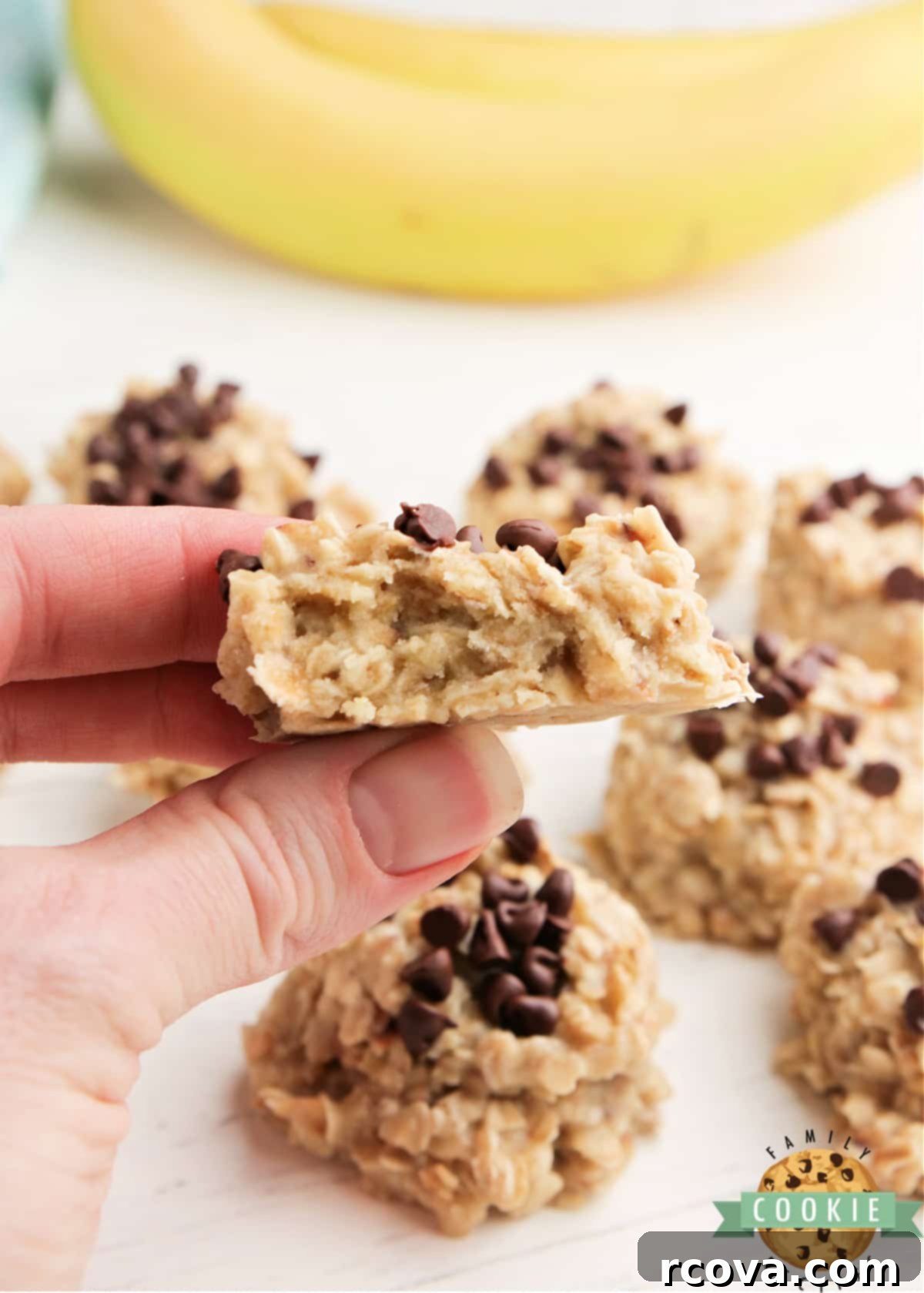 Effortless Banana Oat Treats 11 A close-up shot of a banana no-bake cookie with a bite taken out, revealing its soft and chewy texture.
