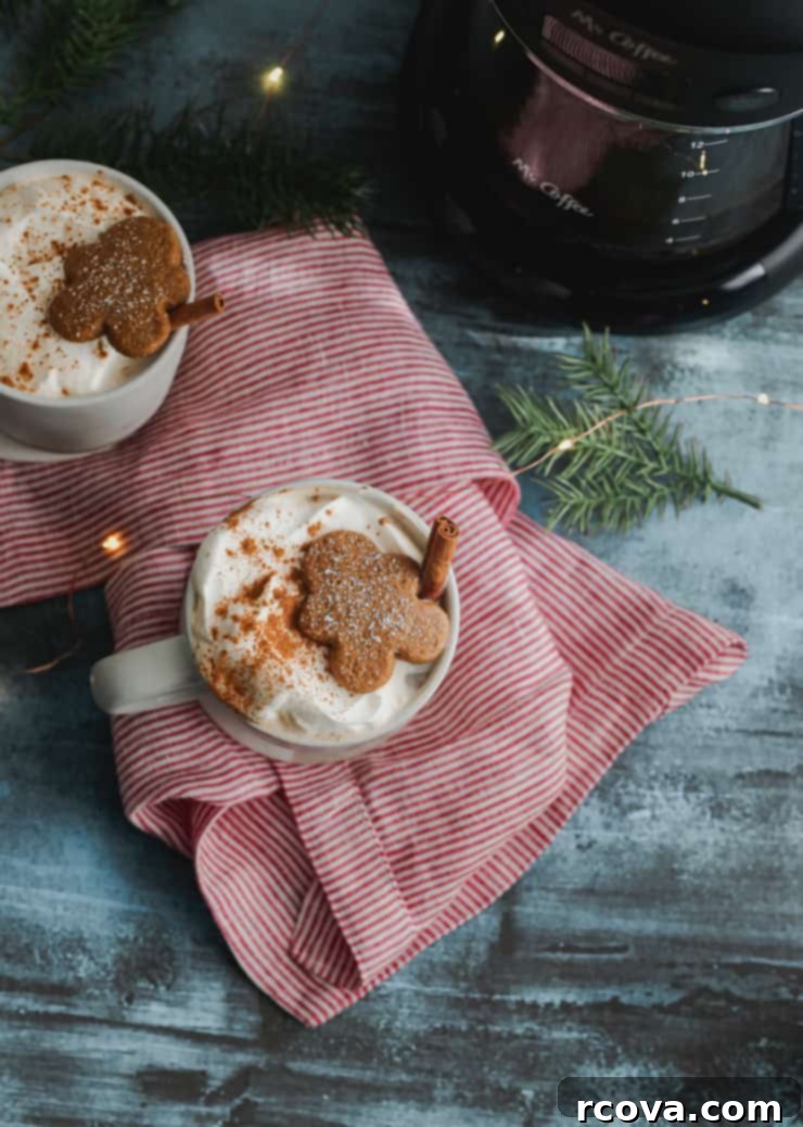 Cozy Homemade Gingerbread Latte 6 Two mugs of homemade gingerbread lattes, garnished with whipped cream and cinnamon.