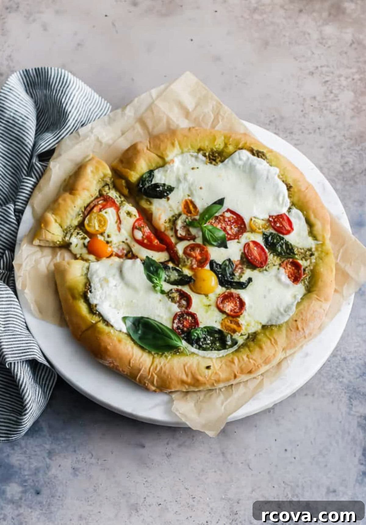 10-Minute Dough Pesto Caprese Pizza 8 whole pizza with tomatoes, pesto and mozzarella cheese.