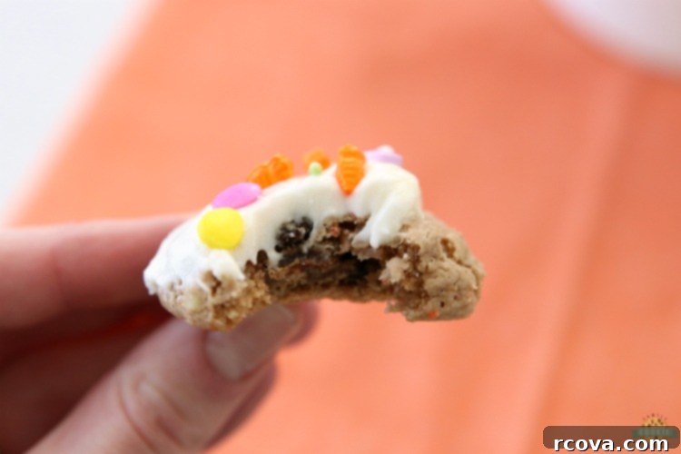 Silent Carrot Delights 11 Carrot cake cookies with cream cheese frosting on a marble surface, ready to be served.