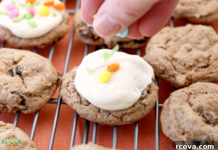 Silent Carrot Delights 7 Cream cheese frosting being spread on a cooled carrot cake cookie.