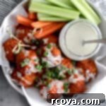 Crispy Air Fryer Buffalo Chicken Meatballs 6 Juicy Air Fryer Buffalo Chicken Meatballs with celery garnish