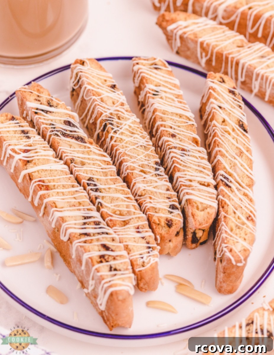 Double-Baked Cherry Delights 5 Close-up of a single white chocolate cherry almond biscotti on a plate