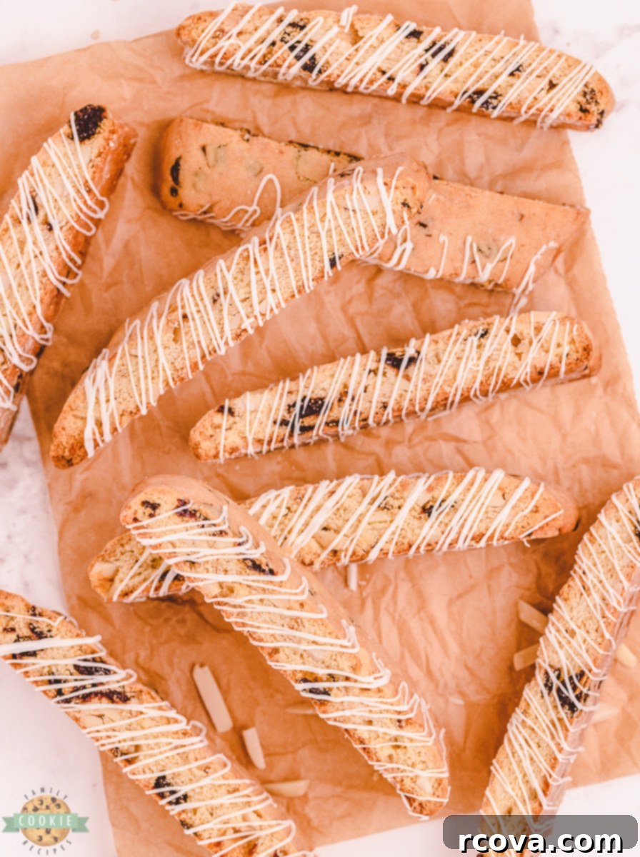 Double-Baked Cherry Delights 8 Baked biscotti logs cooling on parchment paper on a baking sheet