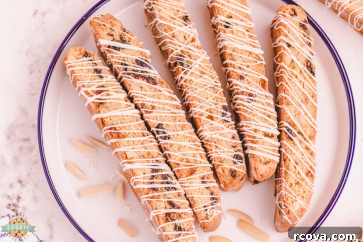 Double-Baked Cherry Delights 9 Beautifully decorated cherry almond biscotti with white chocolate drizzle