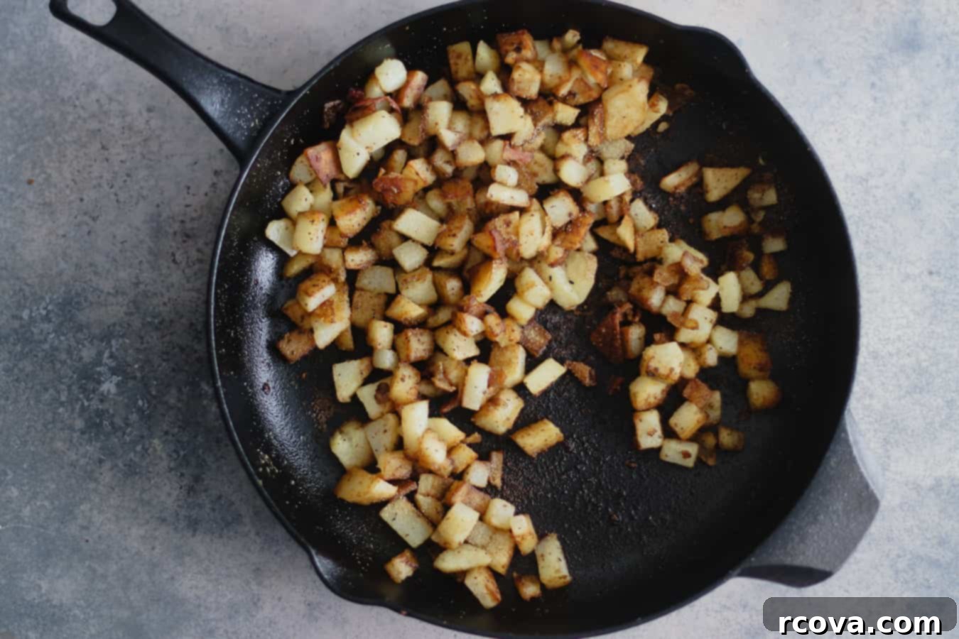 Crispy Skillet Corned Beef Hash 3 Cooking corned beef hash in a cast iron skillet with onions and potatoes