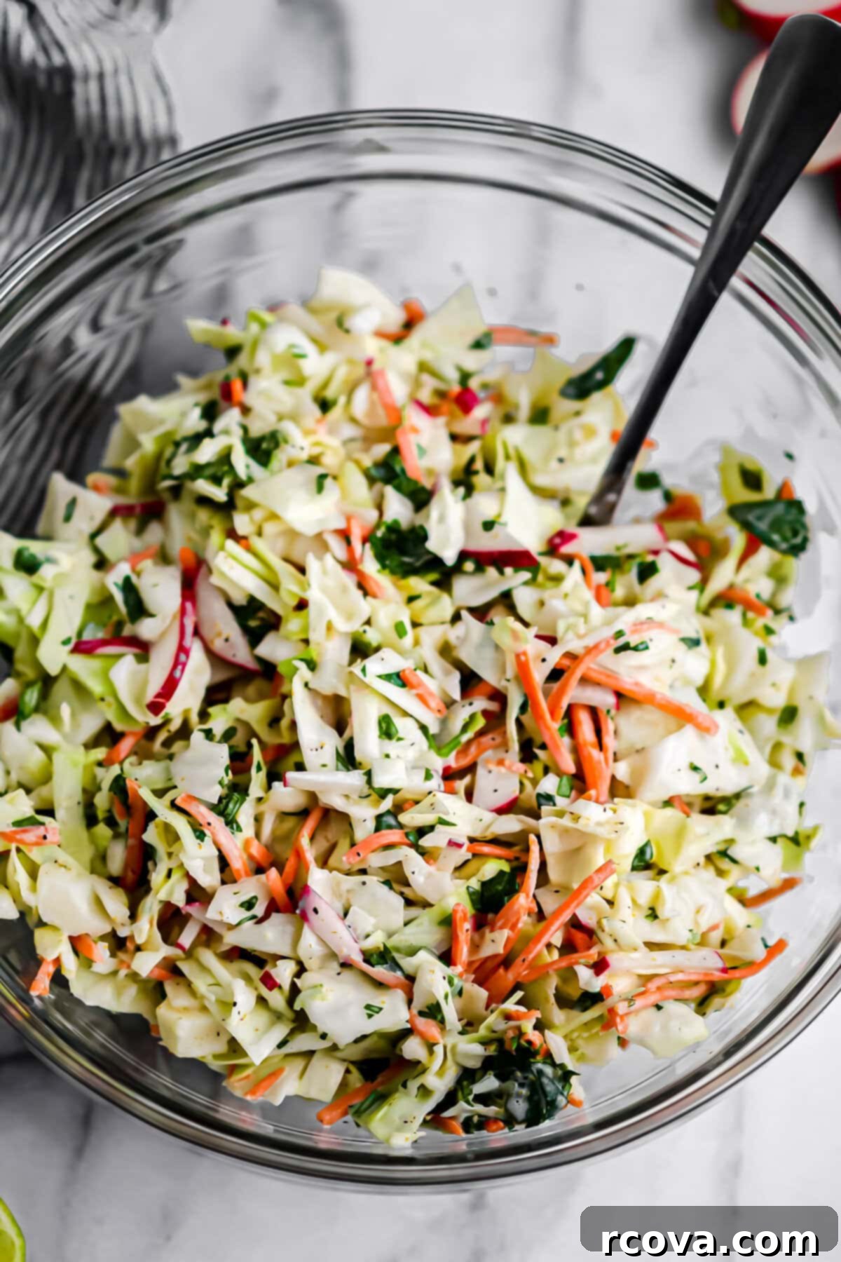 Effortless Zesty Radish Slaw 2 A vibrant bowl of Zesty Radish Slaw, featuring shredded cabbage, bright red radish slices, and fresh cilantro, dressed in a creamy Baja-style dressing.