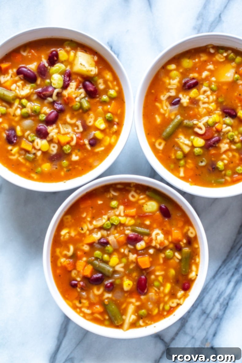 Alphabet Garden Soup 2 Three bowls of vibrant homemade alphabet vegetable soup, garnished and ready to serve