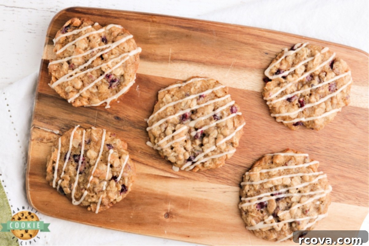 Ruby Glazed Pomegranate Oat Treats 3 Close-up of baked oatmeal cookies generously drizzled with a sweet maple glaze, ready to be served.
