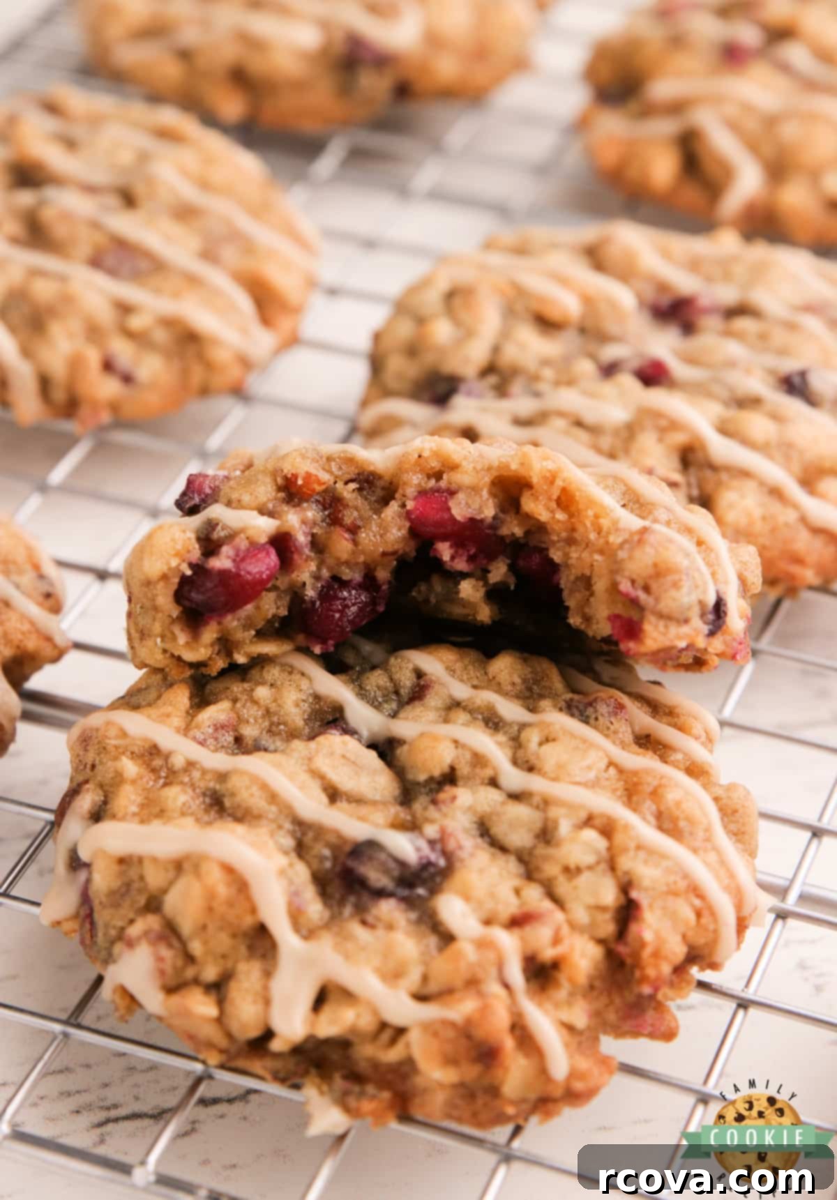 Ruby Glazed Pomegranate Oat Treats 4 Stack of freshly baked oatmeal cookies with visible pomegranate seeds and pecans, ready for glazing.
