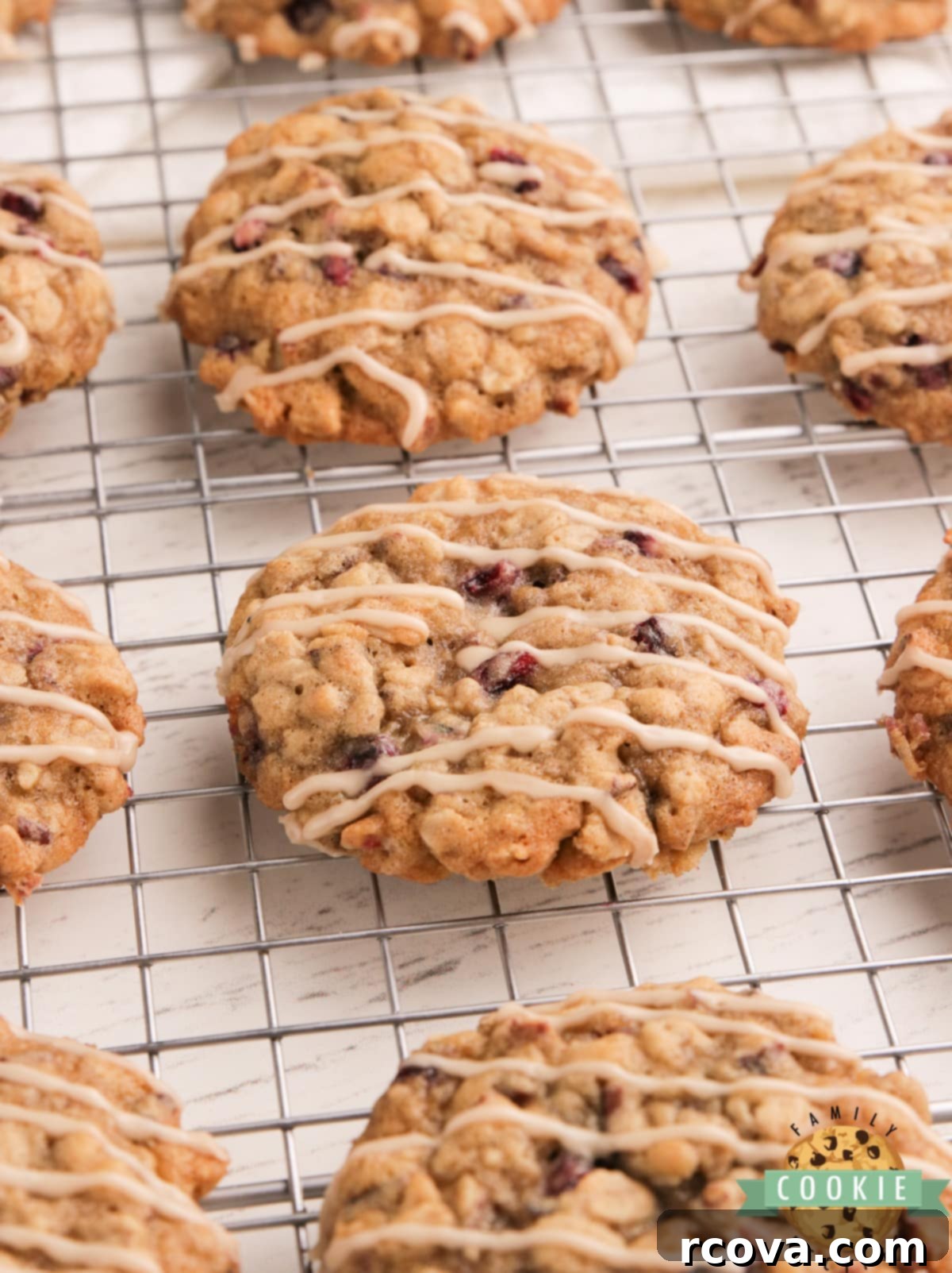 Ruby Glazed Pomegranate Oat Treats 10 Perfectly baked oatmeal cookies with a smooth maple glaze on a wire cooling rack.