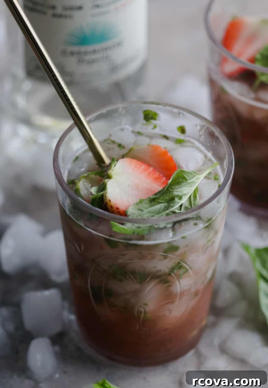 Vibrant Strawberry Basil Margarita 2 Freshly prepared Strawberry Basil Margarita in a glass, garnished with basil leaves