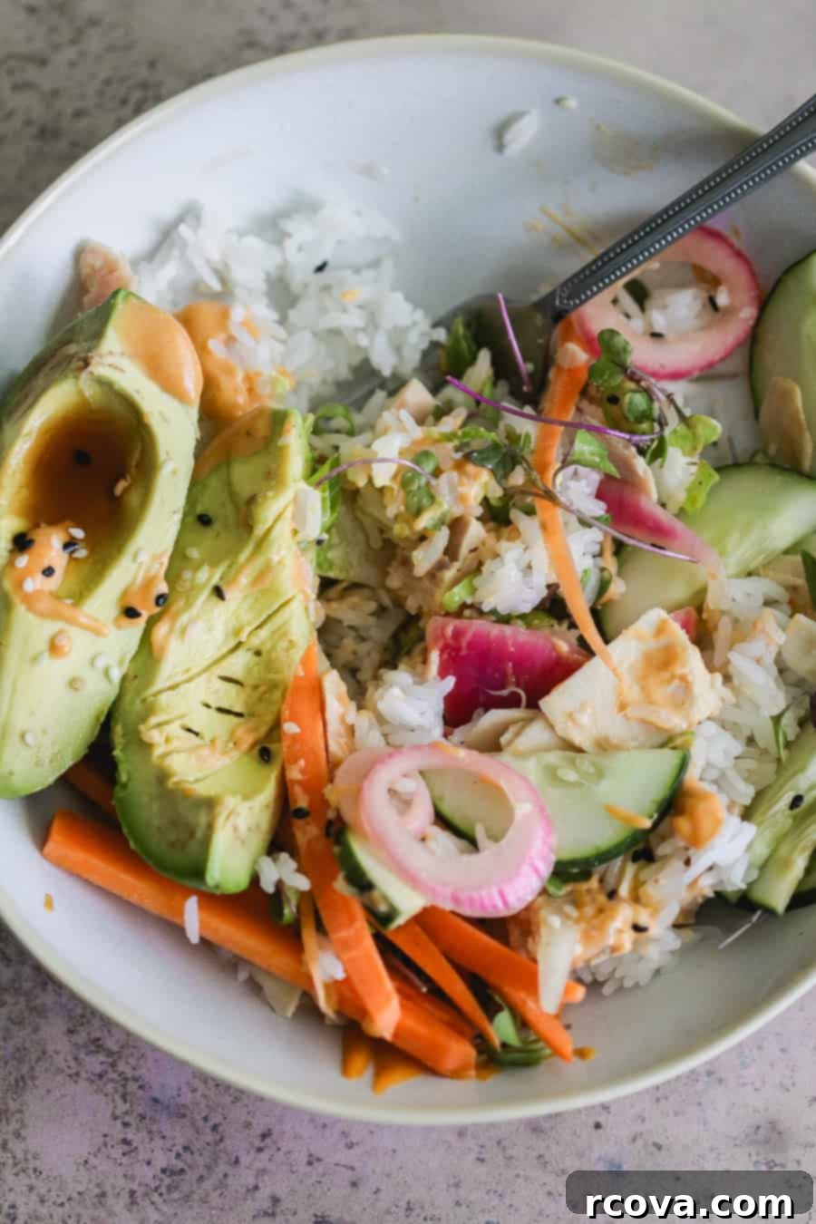 Effortless Canned Tuna Roll Bowl 5 Assembled Tuna Roll Bowl with a variety of fresh toppings and a drizzle of sauce.