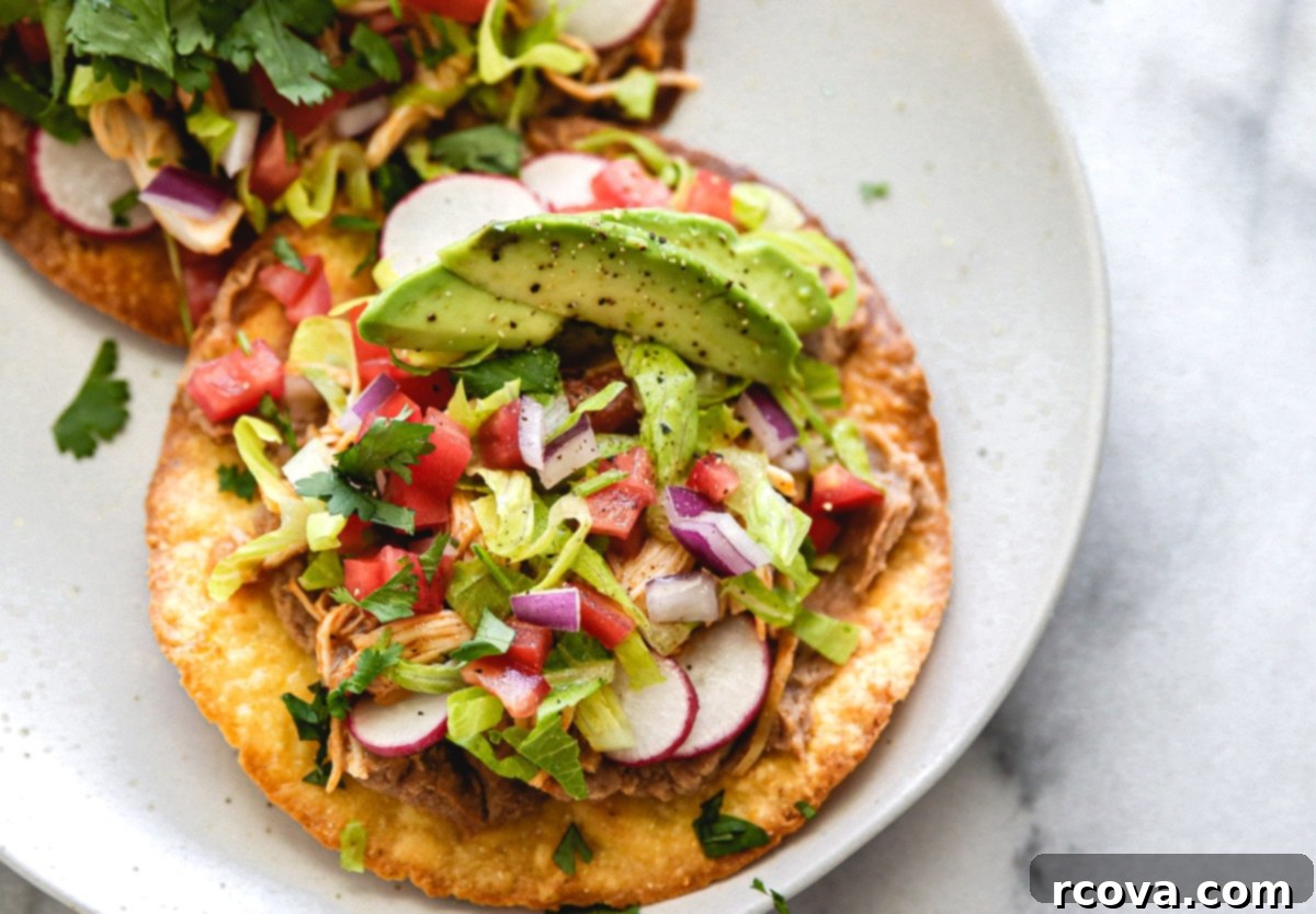 Flavorful Salsa Shredded Chicken for Instant Pot or Slow Cooker 7 Shredded Mexican Chicken served on a tostada