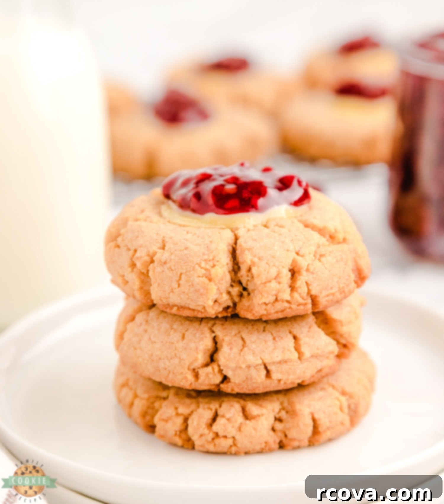 Dreamy Raspberry Cheesecake Cookies 4 A delectable stack of raspberry cheesecake cookies, showcasing the golden cookie base, creamy filling, and vibrant raspberry topping.