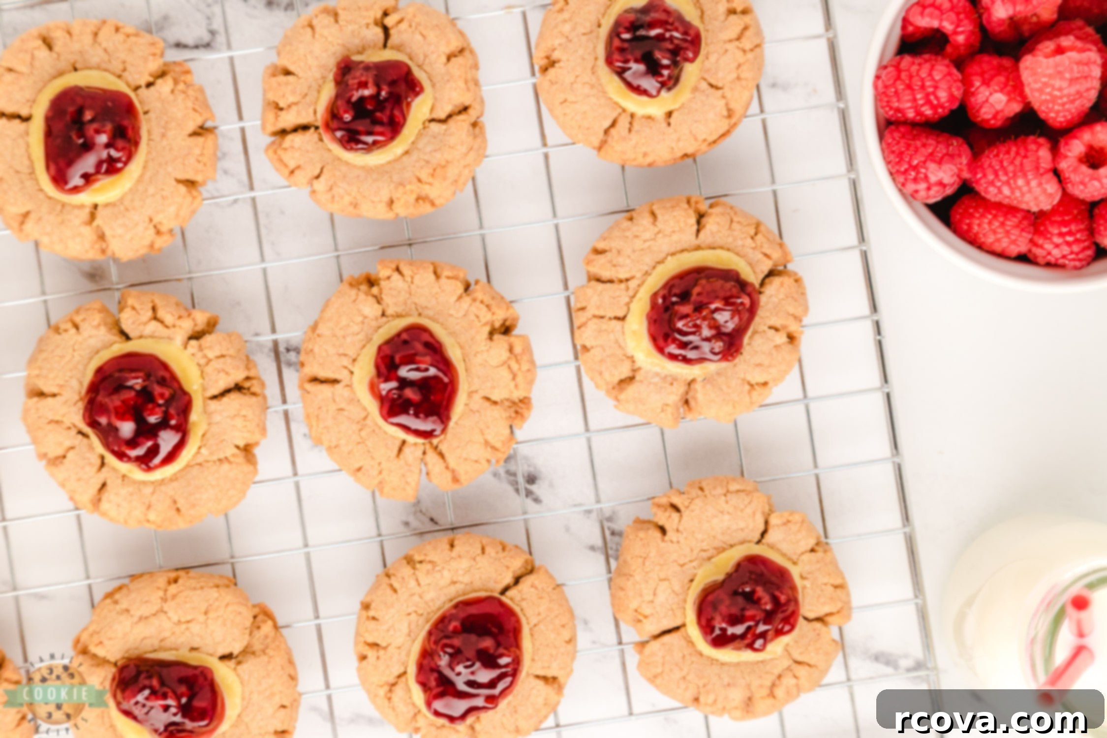 Dreamy Raspberry Cheesecake Cookies 6 Freshly baked raspberry cookies cooling on a wire rack, waiting for their final raspberry topping.