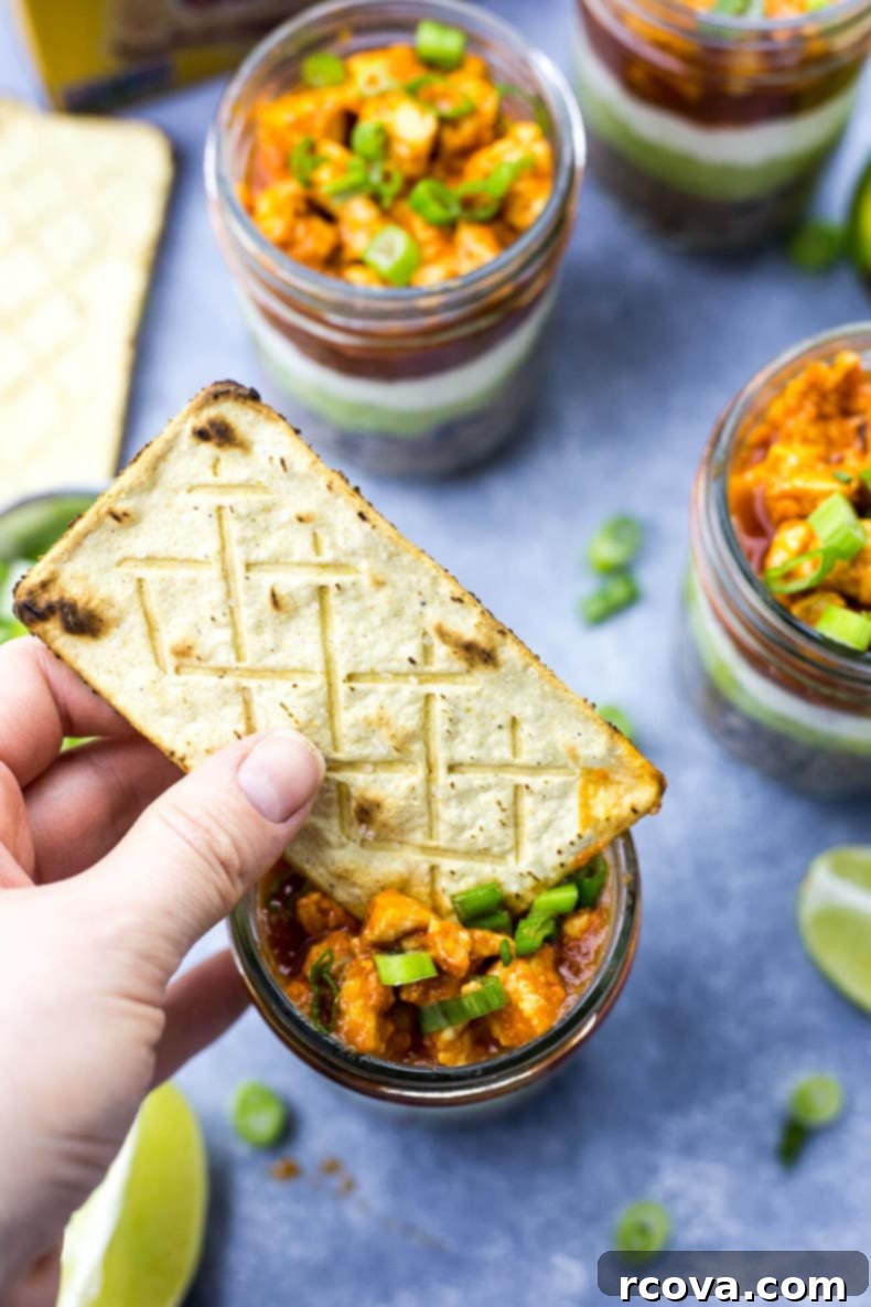 Party-Perfect Stacked Buffalo Chicken Dip Jars 6 Several Mini Buffalo Chicken Salsa Dip Jars lined up, ready to be enjoyed as a party snack.