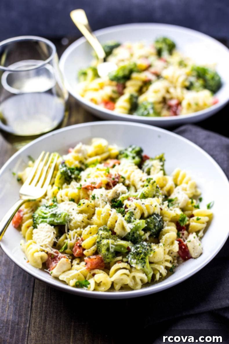 One-Pan Creamy Chicken Broccoli Alfredo 7 Broccoli Chicken Alfredo Skillet garnished with fresh herbs and chili flakes.