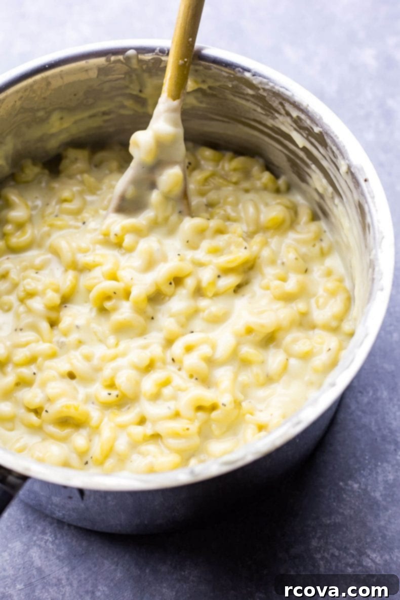 Decadent White Truffle Cheddar Mac 4 A close-up shot of the creamy White Cheddar Truffle Mac and Cheese, garnished with fresh parsley, highlighting its rich and inviting texture.