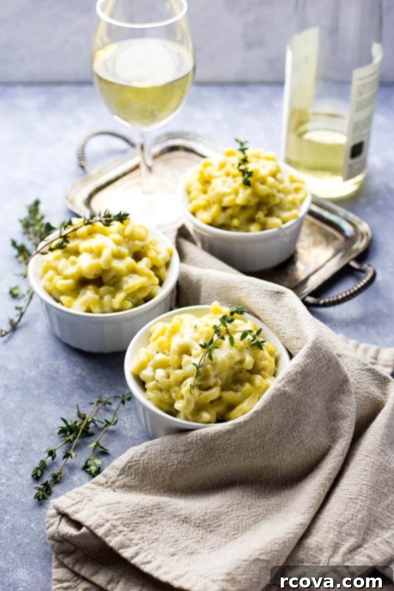 Decadent White Truffle Cheddar Mac 8 A bowl of hot, bubbling White Cheddar Truffle Mac and Cheese, with a spoon digging into its creamy depths, promising a satisfying gourmet experience.
