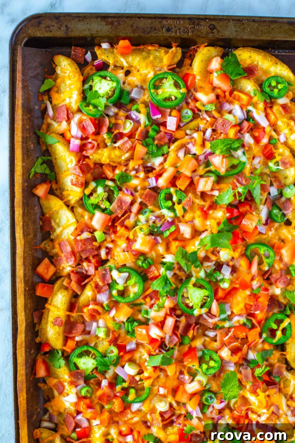Hearty Irish Pub Nachos 7 A tantalizing close-up shot of perfectly cooked Irish nachos, richly loaded with cheese and toppings, served on a sheet pan, ready to be enjoyed.