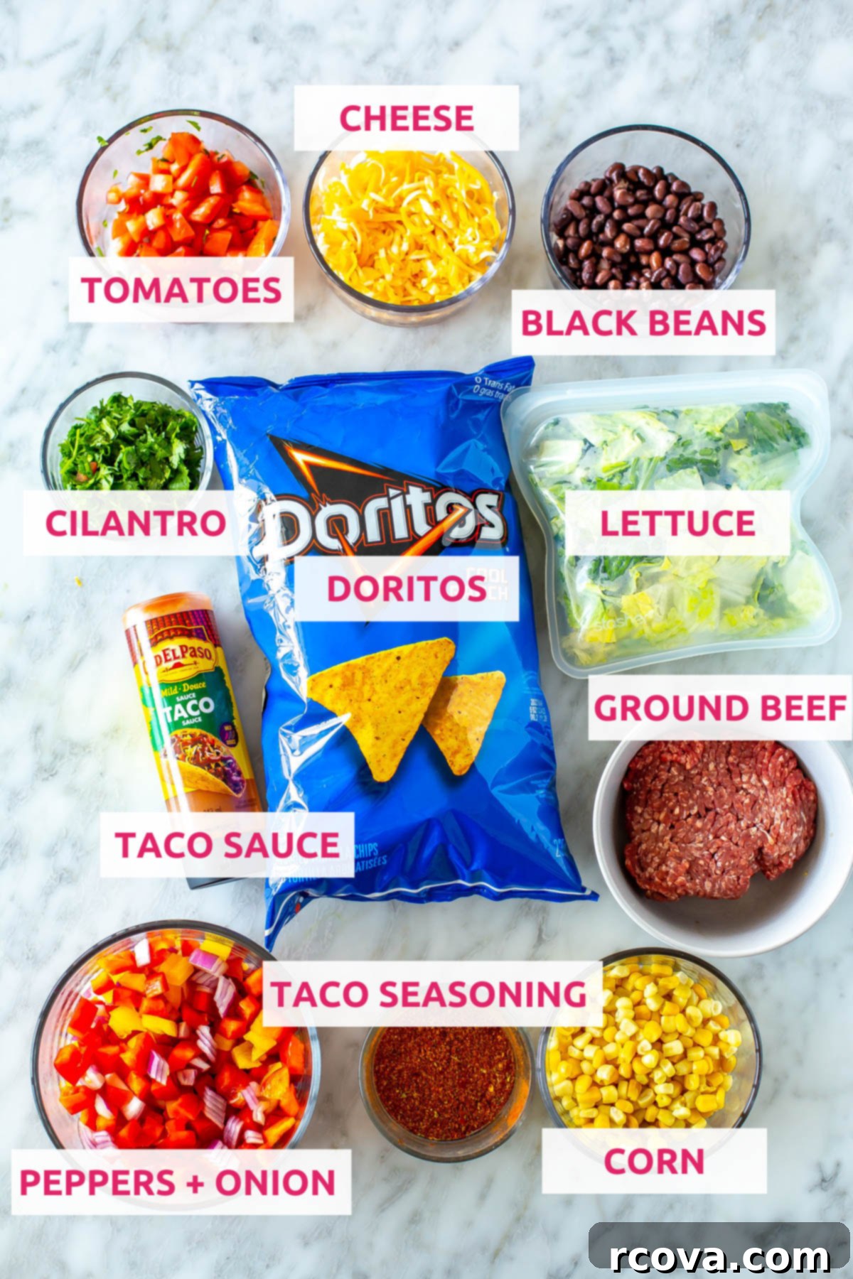 Crispy Dorito Taco Salad 4 A colorful array of ingredients for Dorito Taco Salad, including Cool Ranch Doritos, black beans, shredded cheese, fresh tomatoes, cilantro, crisp lettuce, seasoned ground beef, taco sauce, bell peppers, red onion, taco seasoning, and corn.