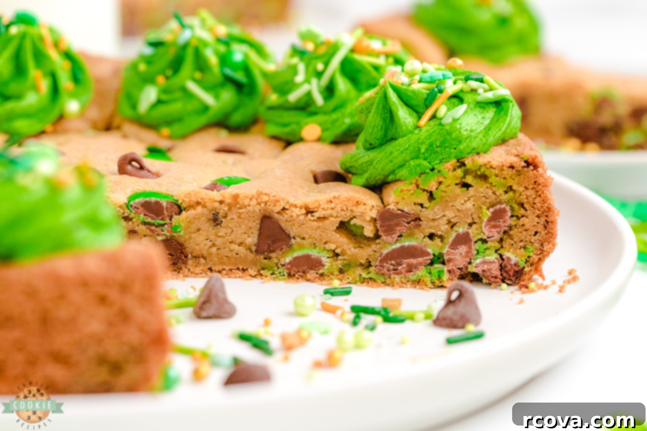 St Patricks Day Green Cookie Cake 2 A delectable slice of a green St. Patrick's Day cookie cake, showcasing its soft texture and green M&M's.