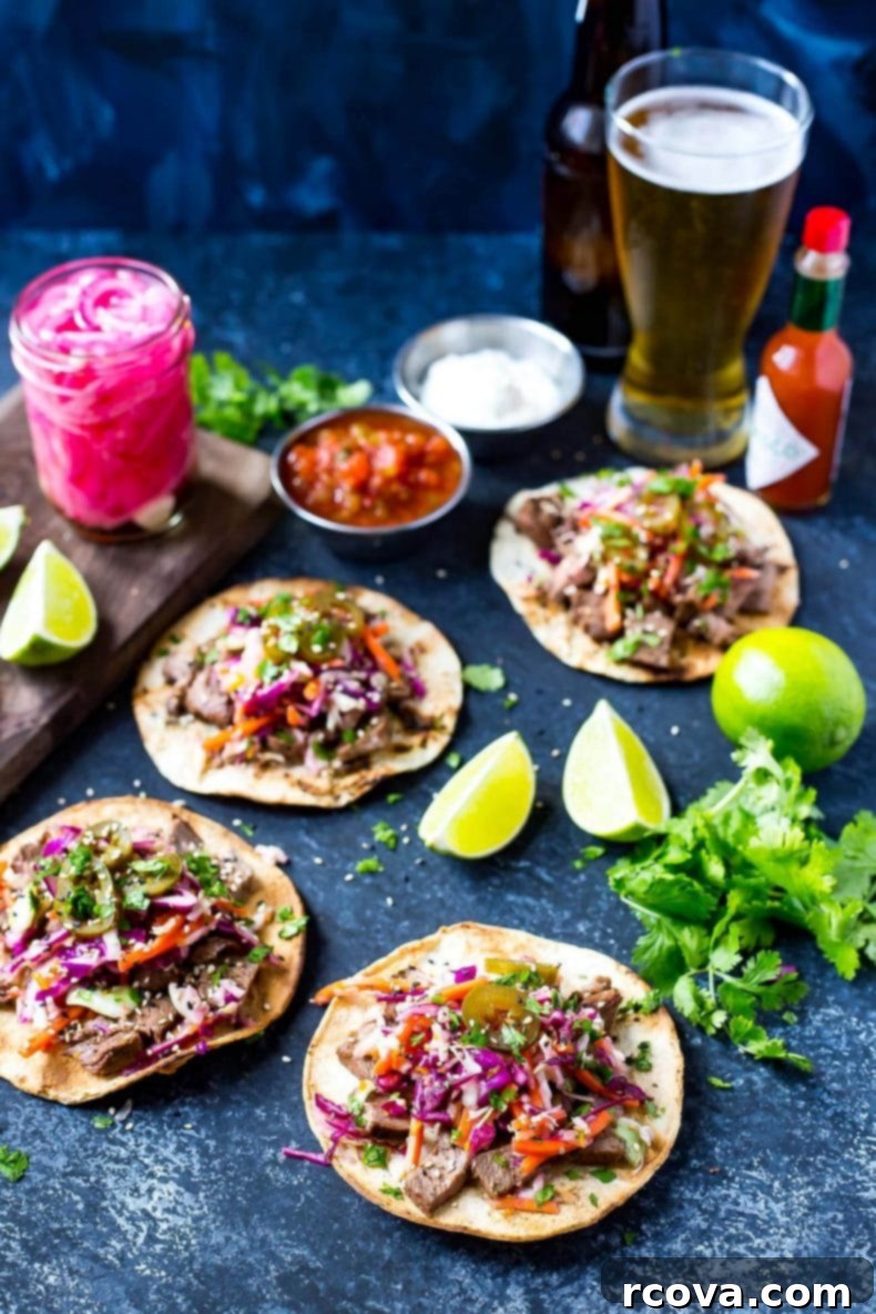 Korean BBQ Kalbi Tacos with Fresh Citrus Slaw 4 Close-up of Kalbi Beef Tacos, showcasing the succulent marinated beef, vibrant citrus slaw, and tangy pickled red onions, all resting on soft corn tortillas. Perfect for an Asian-inspired meal.