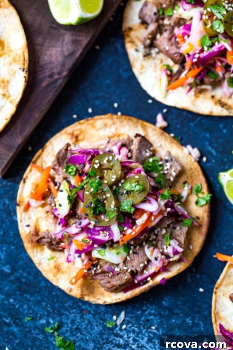 Korean BBQ Kalbi Tacos with Fresh Citrus Slaw 9 A vibrant platter of Kalbi Beef Tacos, showcasing the succulent beef, fresh citrus slaw, and tangy pickled red onions, invitingly ready to be enjoyed.