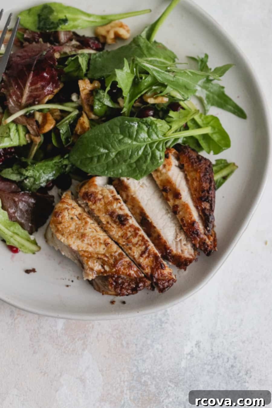 Crispy Air Fryer Dijon Pork Chops 3 Two marinated Dijon pork chops ready to be air fried, showing the rich coating of mustard and spices.