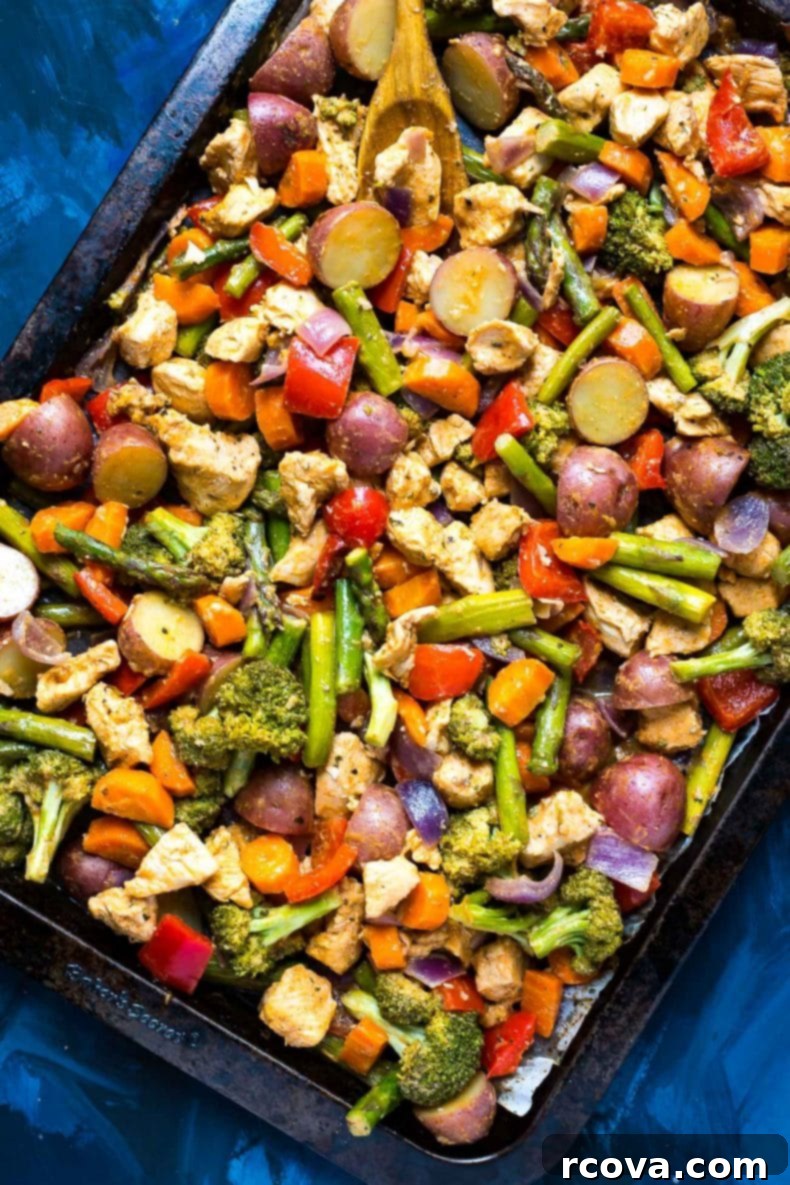 One-Pan Sriracha Ranch Chicken 2 Vibrant Sriracha Ranch Sheet Pan Chicken with fresh broccoli, red pepper, carrots, and asparagus, ready for cooking.
